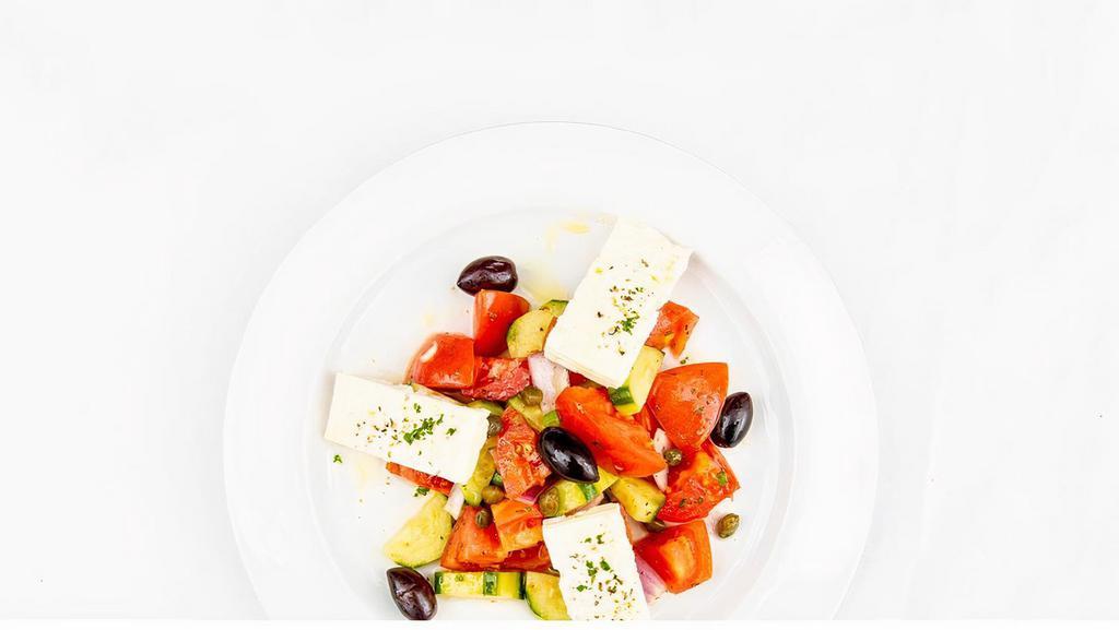 Horiatiki Salata · Salad of tomatoes, feta, cucumber, red onions, olives & oregano.