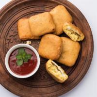 Lazeez Paneer Pakora · Golden crisp batter-fried Indian cottage cheese with a touch of paprika.