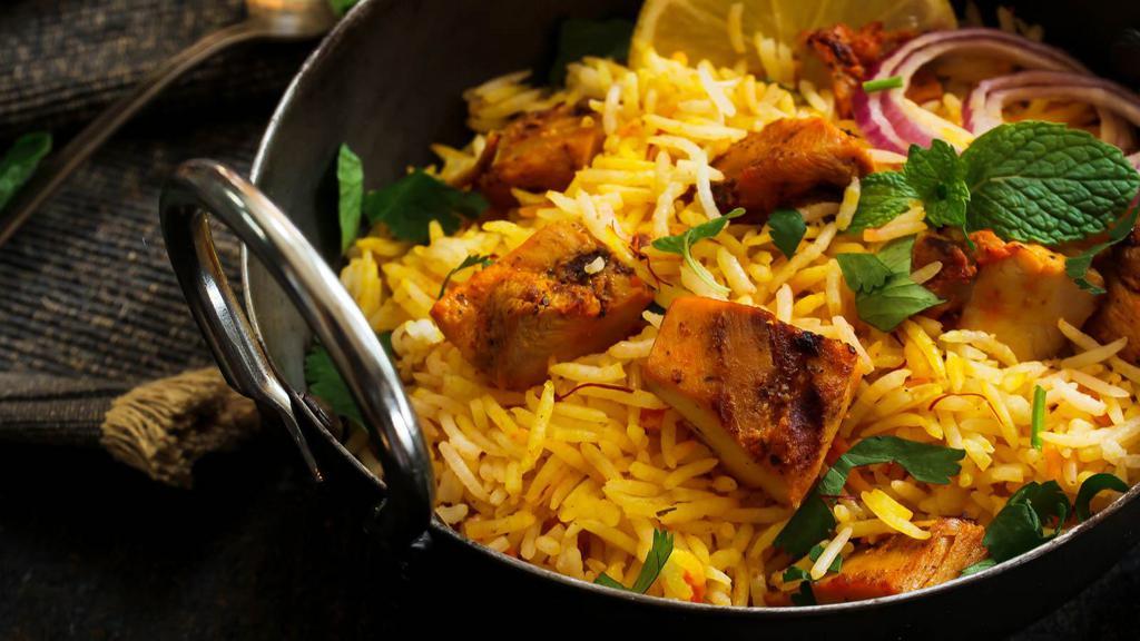 Chicken Biryani · Delicious basmati rice with fresh vegetables, boiled eggs, homemade spices and mint leaves.