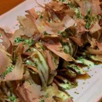 Takoyaki · Deep fried octopus rolled in flour, eggs, scallions, cabbages, seaweeds and dried bonito sha...