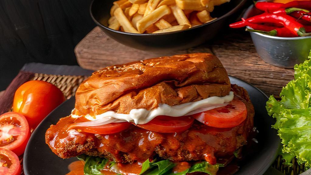 Buffalo Chicken Sandwich · Delicious sandwich made with Buffalo Chicken. Topped with lettuce, tomatoes, cheddar cheese, and mayonnaise.
