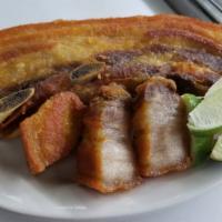 Chicharron De Cerdo  · with tostones, rice and beans or moro