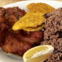 Chuleta Frita · fried pork chop
with tostones, rice and beans or moro