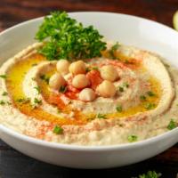 Hummus · Chickpea spread that is blended with tahini, olive oil, lemon juice and garlic. Served with ...