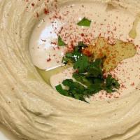 Hummus · Pureed chickpeas with a hint of garlic, lemon, herb, and extra virgin olive oil.