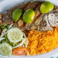 Mojarra Frita · Fried tilapia served with rice and salad.