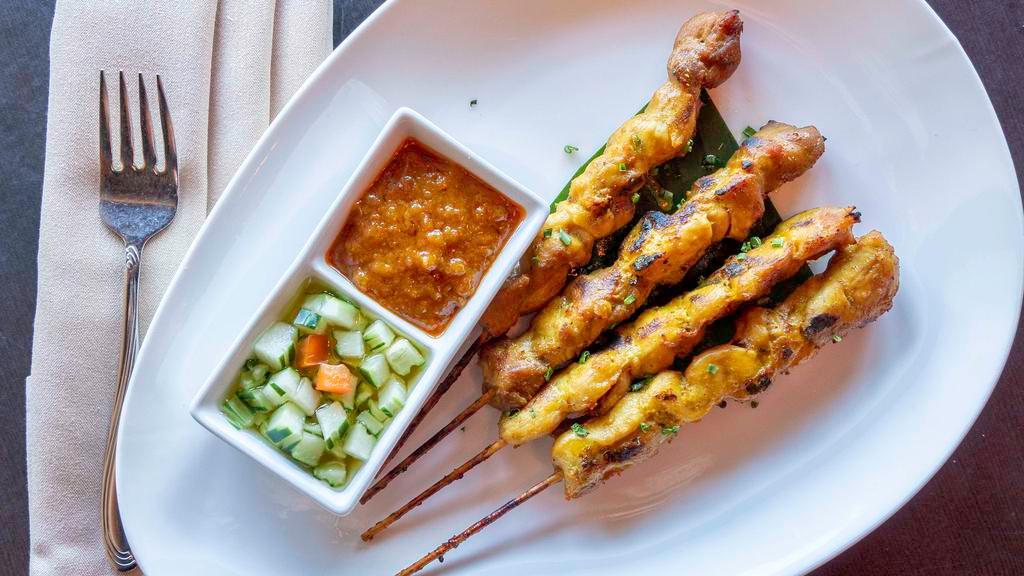 Chicken Sate · Marinated chicken on skewer served with peanut sauce and cucumber relish.