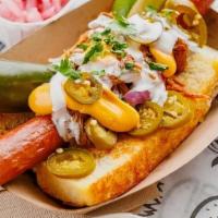 Mexi Birria Dog · Nathan’s Famous all beef FOOTLONG hotdog, pork carnitas, nacho cheese, pickled jalapeños, li...