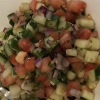 Shirazi Salad · Small and finely-diced cucumber, tomato, onion, mint, lemon vinaigrette.