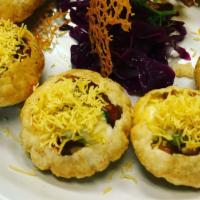 Dahi Batata Sev Poori · Contains gluten. Small pooris filled with lentils and potatoes, topped with yogurt and herbs...