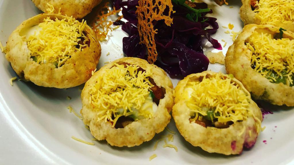 Dahi Batata Sev Poori · Contains gluten. Small pooris filled with lentils and potatoes, topped with yogurt and herbs. A very popular street snack.