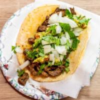 Authentic Taco · Served on a corn tortilla with guacamole, onions and cilantro