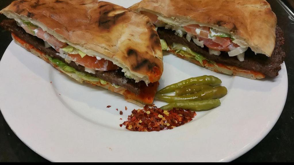 Pljeskavica Bosnian Style Burger · With lettuce, tomato, onions, sour cream and ayvar. Vegetable spread served on warm pita bread. Add feta cheese for an additional charge.