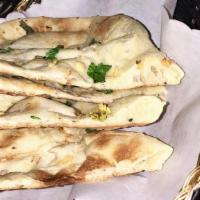Naan · Unleavened bread freshly baked in a clay oven.