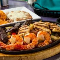 Combo Fajitas · Marinated sizzling strips of tender skirt chicken, steak, and shrimp topped with sauteed oni...