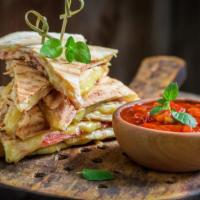 Chicken Tender Quesadilla · Flour tortilla filled with chicken tenders, peppers, onions, avocado, jack cheese, and chipo...