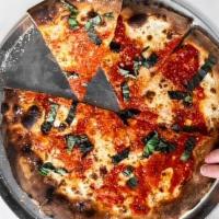 Margherita Pizza · herbal organic tomato sauce, fresh garlic, fresh basil  and melted fresh mozzarella on a reg...
