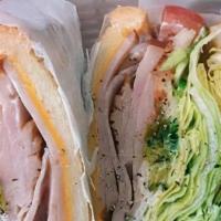 Turkey Delight Sandwich · Honey turkey with pepper Jack cheese, greens and tomato finely sliced onions on raisin bague...