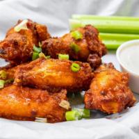 Chicken Wings · Six crispy fried wings tossed in your choice of sauce; buffalo, Parmesan garlic, honey srira...