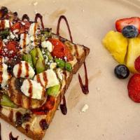 Mediterranean Toast · Your choice of toast with hummus spread. Loaded with sautéed asparagus, tomatoes, and mushro...