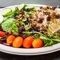 Cranberry Chicken Salad · Creamy chicken salad on a bed of greens. Topped with tomatoes, cucumbers, craisins, and roas...