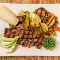Carne Asada Fajitas · Grilled 9-ounce new york strip, pico de gallo, black bean sofrito, queso fresco, and corn to...