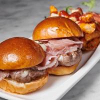 Hamburguesas · two lamb sliders with serrano ham, manchego cheese served with seasoned fries glazed with sp...