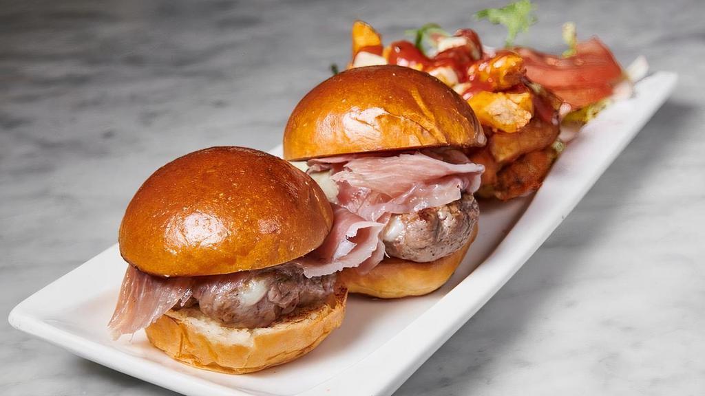 Hamburguesas · two lamb sliders with serrano ham, manchego cheese served with seasoned fries glazed with spicy ketchup and aioli sauce