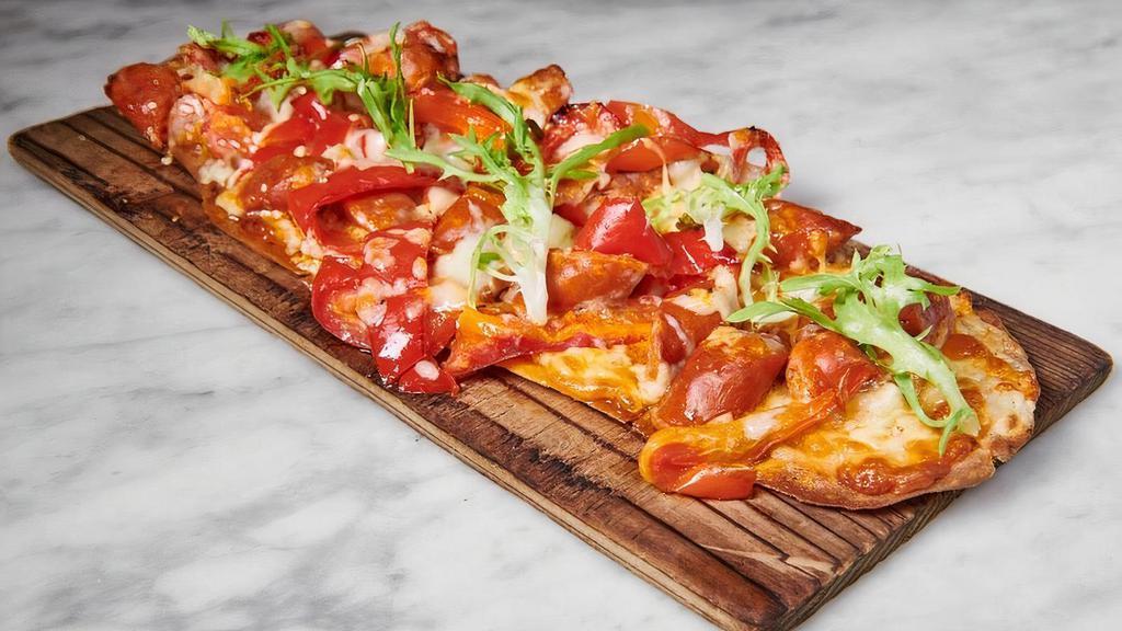 Coca De Chorizo · Flatbread with chistorra sausage,	roasted peppers and manchego cheese