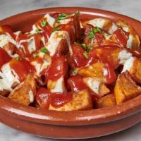 Patatas · Fried potato wedges with spicy ketchup and aioli sauce