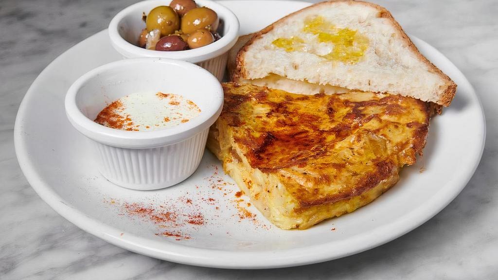 Tortilla · Traditional spanish egg and potato omelet with ailio and mixed olives