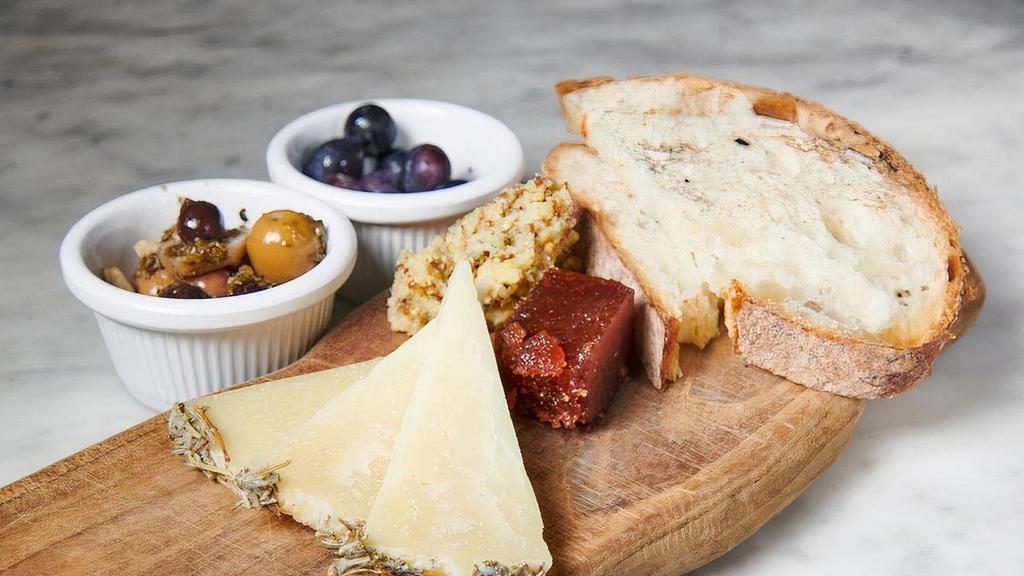 Manchego · Cow cheese, hard, aged in Rosemary.. comes with olives, grapes, quince paste, bread and home made butter (butter, chives, dijon mustards seeds, rosemary, )