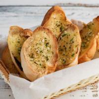 Garlic Bread · House made garlic bread prepared with fresh garlic, warm butter, and herb seasoning.