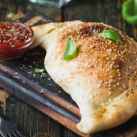 Meatball Calzone · Hearty beef meatballs and creamy cheese folded into a fresh made calzone.