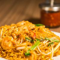 Golden Dragon Chow Mein · Shrimp, beef and chicken stir-fried with mixed vegetables on a bed of pan-fried thin Chinese...