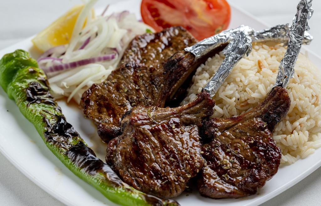 Lamb Chops · Baby lamb chops (4 piece) broiled to taste. It is served with rice and grilled vegetables.