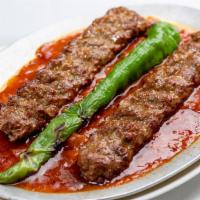 Has Has Kebab · Skewered ground meat on a bed of special tomato sauce. It is served with rice and grilled ve...