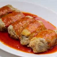 Lahana Sarma · Cabbage leaves stuffed with rice, meat, pepper, onion, and herbs. It is served with yogurt s...