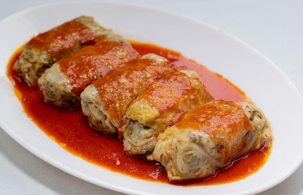 Lahana Sarma · Cabbage leaves stuffed with rice, meat, pepper, onion, and herbs. It is served with yogurt sauce.