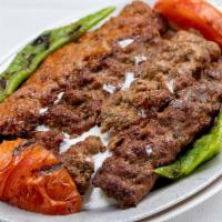 Adana Kebab With Yogurt · Layers of skewered ground beef, fried bread and garlic in yogurt sauce.