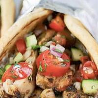 Pita Wrap · Grilled chicken or falafel wrapped in a warm pita topped with tomato, cucumber, and lettuce ...