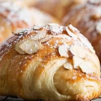 Almond Croissant · Melt-in-your-mouth croissant filled with almond paste and topped with shredded almonds.