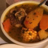 Oxtail Soup · Potatoes, yuca, corn, carrots, and meat. Served with a side of white rice, onions, cilantro,...
