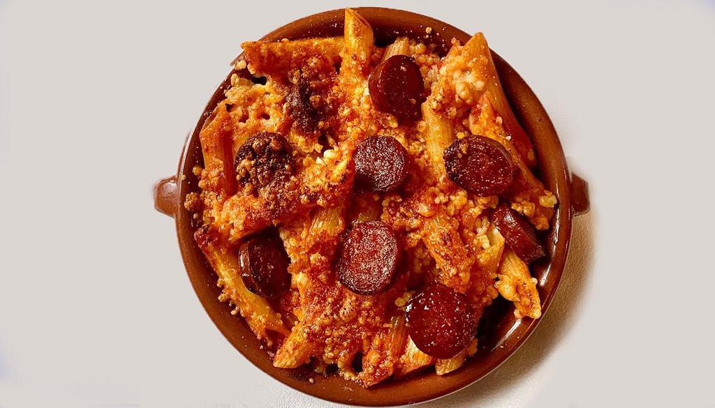 Macarrones Con Chorizo · Baked penne pasta with tomato, chorizo, and Manchego cheese