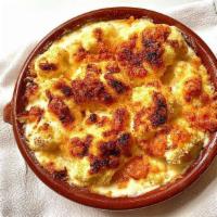 Coliflor Gratinada · Baked cauliflower with a gratin of béchamel sauce and Manchego cheese