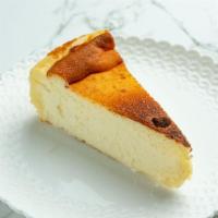 Tarta De Queso · Slice of cheesecake made with cream cheese, goat cheese, eggs, cream, and sugar, baked at a ...