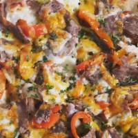 Philly Cheese Steak Pizza · Fresh Philly steak mixed with red and green peppers, onions, and mushrooms topped with yello...