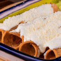 Flautas · 4 tortillas rolled up and deep fried. Topped with Mexican cream, powder cheese and accompani...