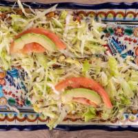 Huaraches · 2 thick corn tortillas spread with beans, Mexican cream, powder cheese, topped with lettuce,...