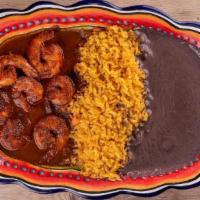 Camarones A La Diabla · Grilled shrimp marinated in chipotle sauce accompanied with rice, black beans, fresh salad &...